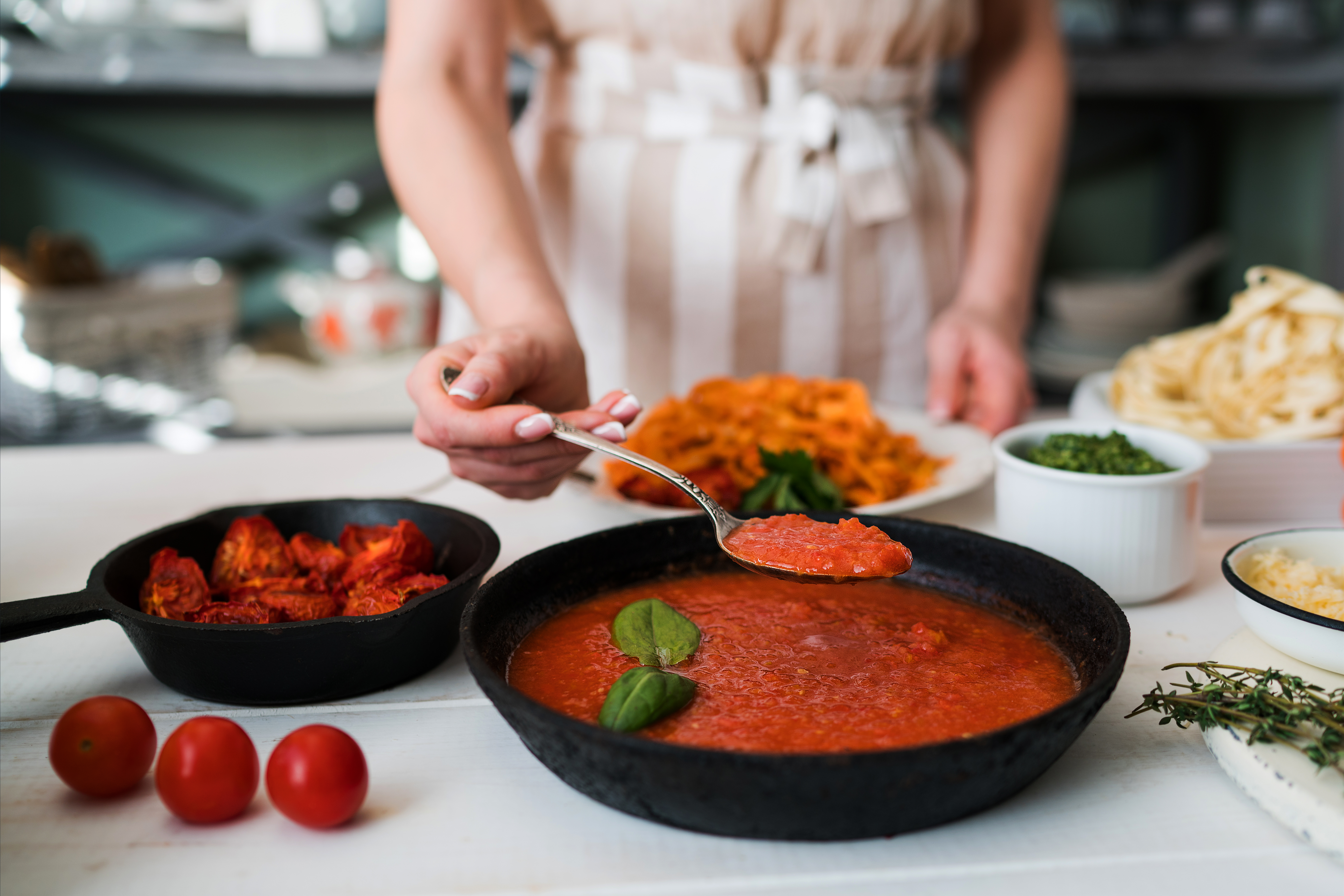 Make kitchen. Two people are Cooking pasta in Sauce.